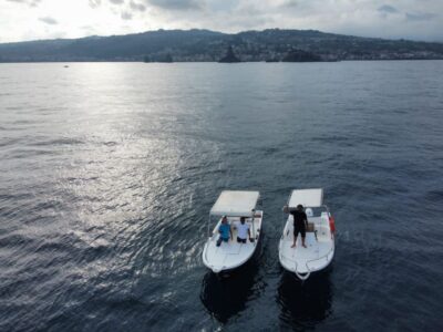 boat tour exploring and searching for dolphins in Acitrezza