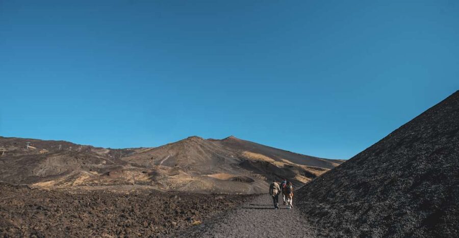 Catania: Etna Morning Excursion with Tasting and Pickup - The volcanic cave stop, helmets on, flashlight ready