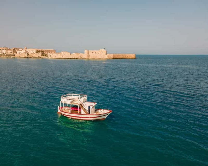 Syracuse: Boat Trip with Lunch, Wine, and Swimming Stops - Getting on board at Dolci Escursioni, then cruising at a calm pace
