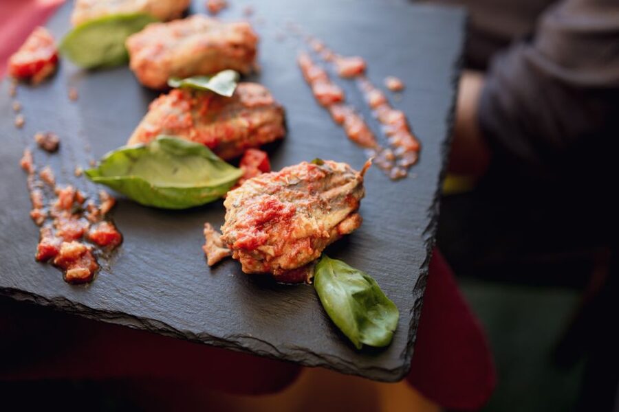 Taormina: Shared or Private Food & Wine Walking Tour - Stop two: land flavors with Sicilian red wine at a local-style bite